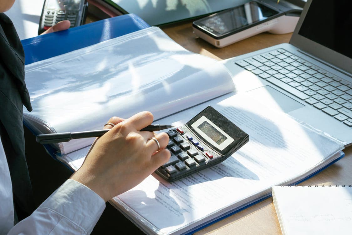 Person using a calculator for financial analysis